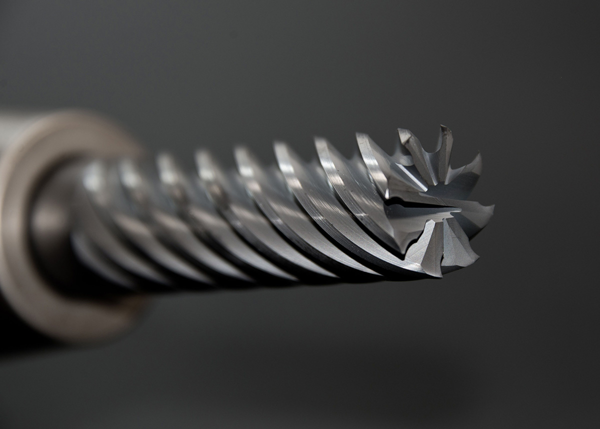 The carbide end mill is the workhorse of CNC milling — each flute removes a chip of material with every revolution, building complex shapes one cut at a time.
